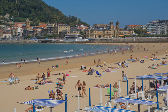 People enjoy the seaside at La Concha beach in San Sebastian, Basque Country, Euskadi, Spain, Europe