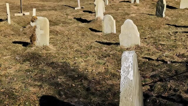 Ancient cemetery graveyard with old gravestones for people buried long ago