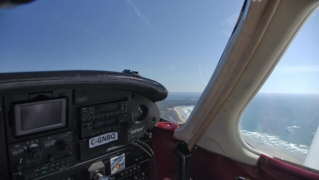 Plane Overflying Beautiful Beach on a Sunny Day, View from Cockpit