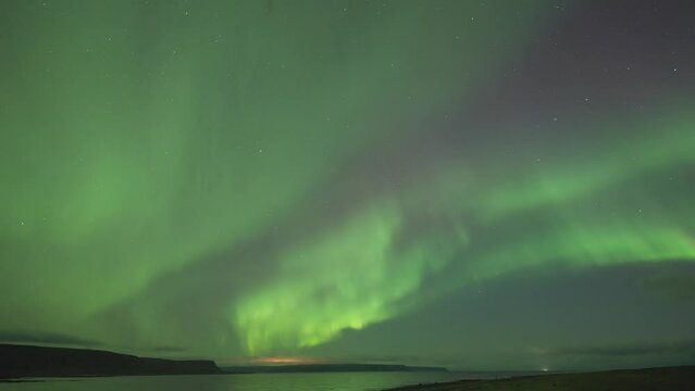 The dark sky adorned with a spectacular exhibition of the northern lights.