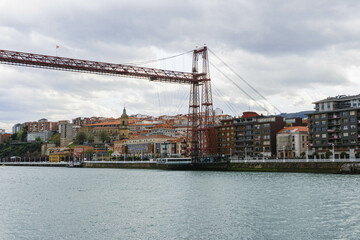 hanging iron red bridge over the river in north of spain vizcaya 