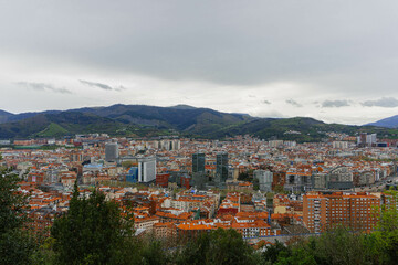 Naklejka premium panorama of the city of bilbao with cloudy sky and mountains 