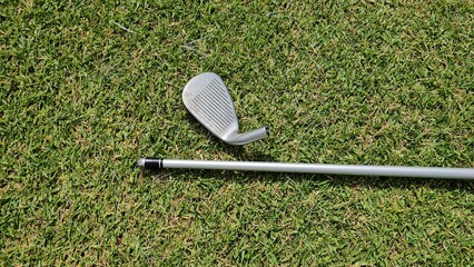 Golf Club and Putter on Grass