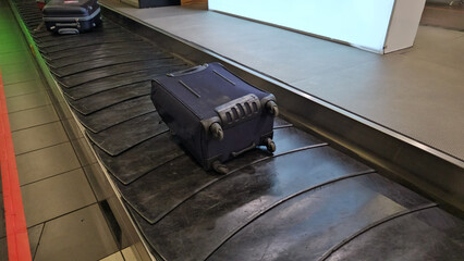 Suitcase on Top of Conveyor Belt