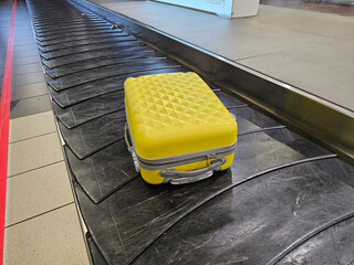 Yellow Luggage on Conveyor Belt