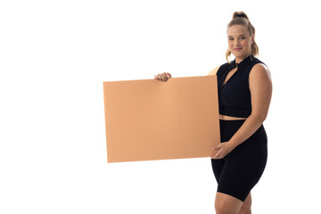 Plus size Caucasian woman in black dress holds blank sign on white background - 792789525