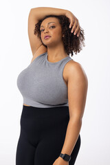 A biracial young female plus size model poses on white background - 792789597
