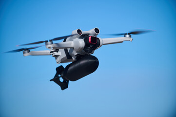 A civilian drone with a small bomb on board is flying in the sky