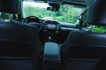 Interior of off road car in the rainy forest montains