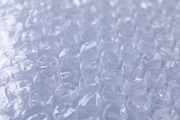 Transparent bubble wrap on gray background, closeup