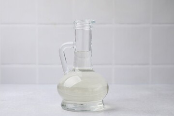 Vinegar in glass jug on light table