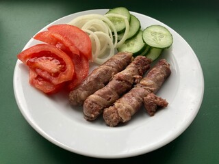 Cooking cevapchichi Balkan meat sausages