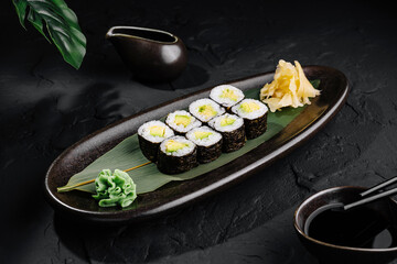 Elegant sushi platter on dark stone background
