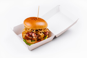 Gourmet burger in takeout box on white background