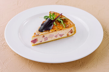 Gourmet quiche slice on elegant white plate