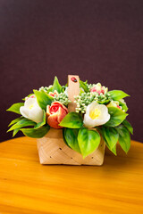 Cute bouquet of handmade soap flowers a small table.