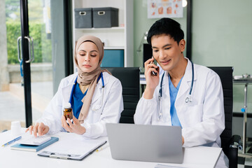  Doctor Talks With Professional Head Nurse or Surgeon, They Use Digital tablet Computer. Diverse Team of Health Care Specialists Discussing Test Result on desk