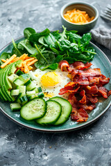 bacon avocado eggs and spinach on a plate. Selective focus.
