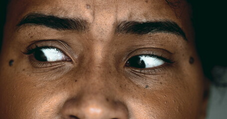 One Horrified Young Black Woman in Macro Close-Up, Eyes Wide Open in Shock looking sideways,...