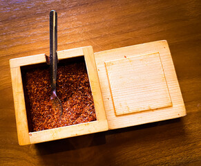 chili powder in a wooden container