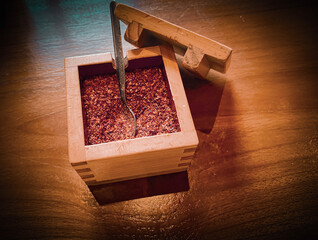 chili powder in a wooden container