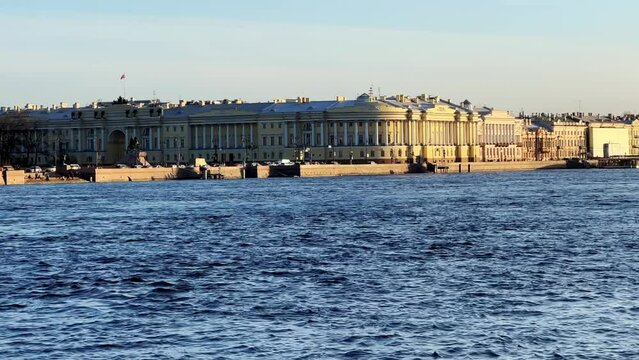 St. Petersburg, Russia - April 20, 2024. The University embankment of the Neva River. View of the sights of the city from the palace bridge. Panoramic view of the Neva River and the Palace embankment.