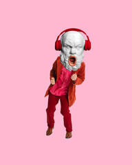 Man with antique statue bust, in red suit listening to music in headphones and dancing. Contemporary art collage. Concept of creativity, retro and vintage style, imagination, surrealism, music, party
