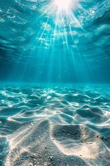 Under the clear blue sky, the golden sand of the ocean floor is visible as the sun's rays dance on...