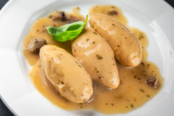 quenelles pork mushroom sauce canned food jar put food on a plate eating cooking appetizer meal food snack on the table copy space food background