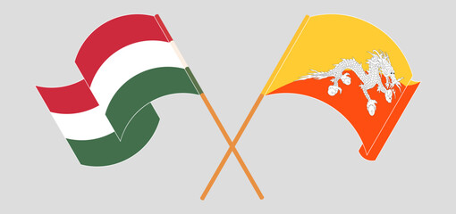 Crossed and waving flags of Hungary and Bhutan