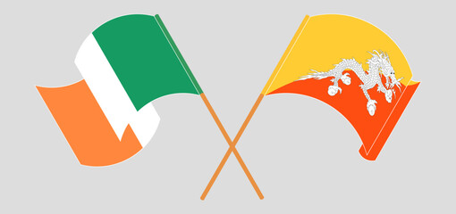 Crossed and waving flags of Ireland and Bhutan
