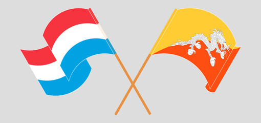 Crossed and waving flags of Luxembourg and Bhutan