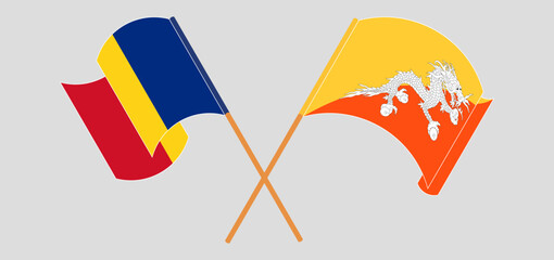 Crossed and waving flags of Romania and Bhutan