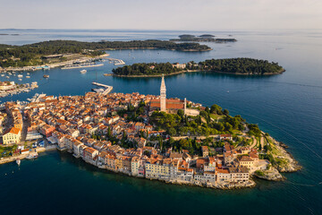 Rovinj, Croatia: Dramatic aerial view of the famous Rovinj medieval old town with its Venetian campanile in Istria by the Adriatic sea in Croatia - obrazy, fototapety, plakaty