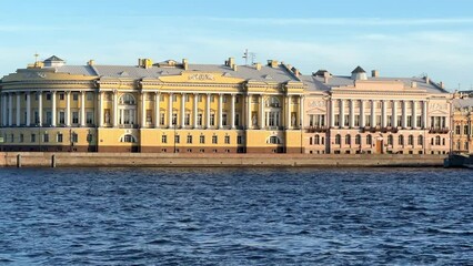 St. Petersburg, Russia - April 20, 2024. The University embankment of the Neva River. View of the sights of the city from the palace bridge. Panoramic view of the Neva River and the Palace embankment.
