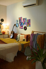 Bedroom of teenagers who play is guitar, basketball and listens to old music