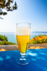 Glass of cold beer on a table in a hot country during vacation.