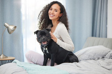 Happy, woman and portrait with dog in bedroom on holiday or relax in morning on vacation with pet....