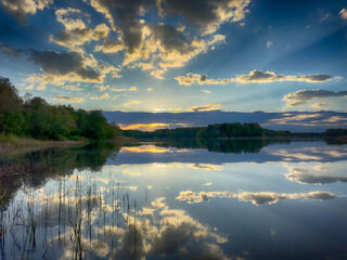 Serene Fishing Lake: A peaceful scene by the tranquil waters of a secluded fishing lake. Surrounded...
