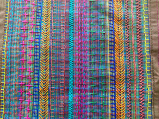 Blue multi colored woven fabric with colorful different hand stitching on cotton fabric