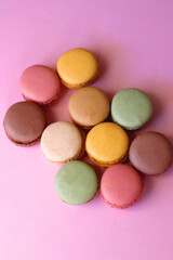 Colorful macarons on pink background. Selective focus.