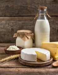 Dairy products on wooden background. A bottle of Milk, sour cream, cottage cheese, cottage cheese, cottage cheese