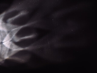 Light reflected on a steel surface in the dark for an abstract background, energy or mystery.   