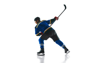 Ready to attack, skilled player, geared up and focused, glides with stick held high against white studio background. Concept of professional sport, competition, movement, energy, tournament, match. Ad