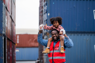 A man is holding a young girl on his shoulders. The man is wearing a safety vest and the girl is...