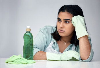 Frustrated, woman and thinking about cleaning with gloves, detergent and cloth for house chores in...
