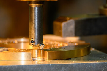 The NC milling machine chamfer cut the brass material parts.