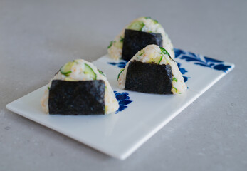 Homemade Onigiri Kyuri, rice triangle with cucumber, sesame seeds, ginger, nori seaweed