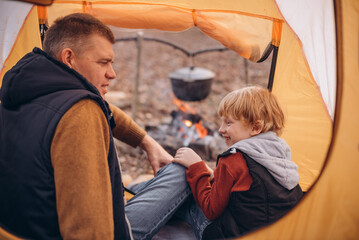 Man and boy tourists autumn time leisure, vacation hiking or traveling touristic activity. Family...