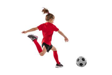 Portrait of little girl in motion, training, playing football against transparent background. Sportive and active kid. Concept of action, team sport game, energy, vitality.